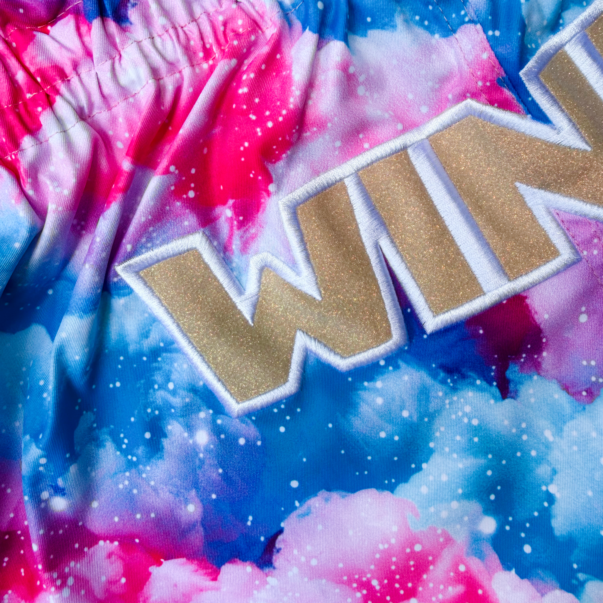 Blue and Pink Clouds Print with golden glitter WINKO logo at the front.  Premium Quality Muay Thai shorts designed for unrestricted movement and reliable performance.

Quick-dry and lightweight
Flexible fabric
Side slits for freedom of movement
Adjustable waistband 
Sublimation print
Embroidered logo