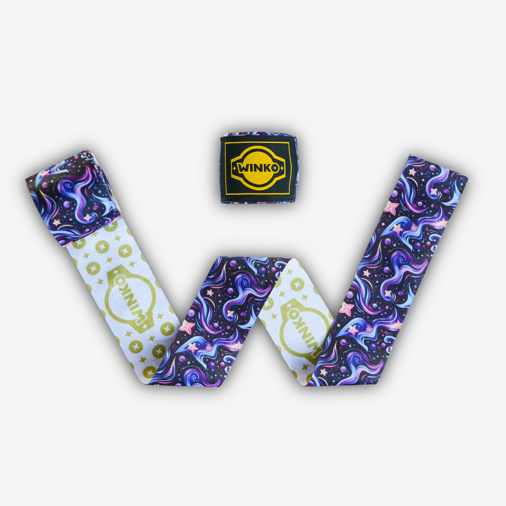 Two boxing hand-wraps - blue and purple galaxy pattern on black background. Reverse side is also printed with a repeated gold WINKO logo pattern on white background.

Engineered to deliver optimal support and protection. The dual-sided sublimation print offers two style options: wrap either way for a different look.

Thin profile and smooth-touch surface
Lightly elastic blend
Lightweight
Integrated thumb loop, Velcro strap