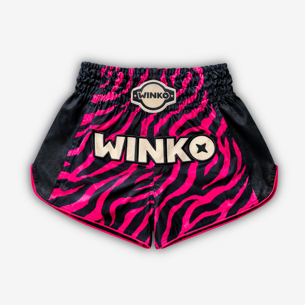Black and Pink Tiger Strip Print, Black Glittery Sides, Golden Glittery Front Logo.
Muay Thai shorts designed for unrestricted movement and reliable performance.

From the Midnight Hunt Collection

KEY FEATURES:
Quick-dry and lightweight
Flexible fabric
Side slits for freedom of movement
Adjustable waistband
Unique sublimation print
Embroidered logo